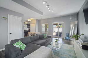 Living area with wood finished floors and baseboards