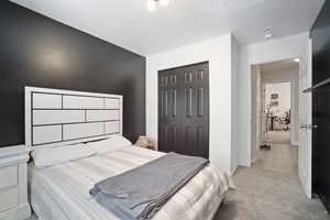 Bedroom featuring a closet, carpet floors, and baseboards