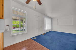 Entryway with a ceiling fan, baseboards, and wood finished floors