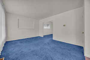 Spare room with carpet floors and baseboards