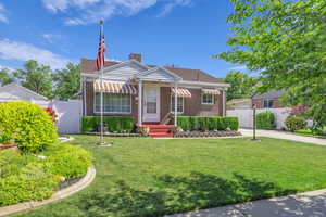 Bungalow featuring brick siding and a gate