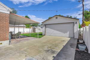 Detached garage featuring a storage shed