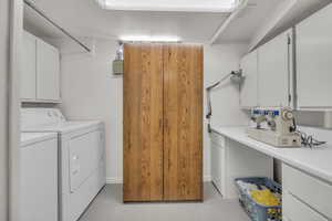 Laundry area featuring cabinet space