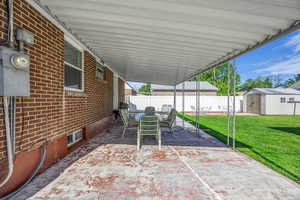 View of patio / terrace featuring an attached carport and outdoor dining area
