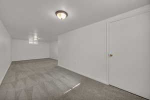 Below grade area featuring carpet flooring and baseboards