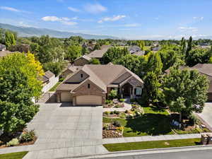 Aerial view of property and surrounding area with a mountain backdrop