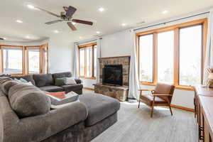 Living area featuring a fireplace, plenty of natural light, baseboards, recessed lighting, and a ceiling fan