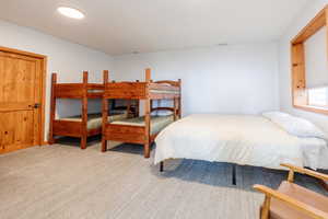 Bedroom featuring light colored carpet