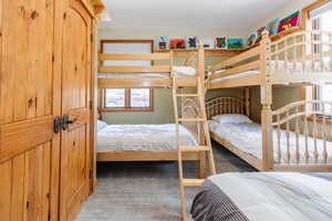 Bedroom with carpet floors and multiple windows