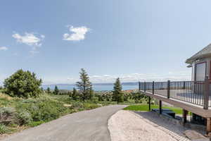 Surrounding community featuring a deck with water view