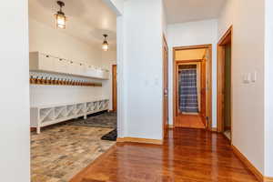 Hall with baseboards and wood finished floors