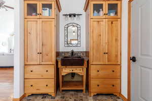 Interior space with vanity and stone finish flooring