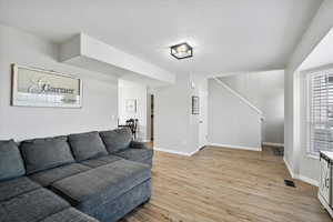 Living area featuring laminate floors, updated light and paint