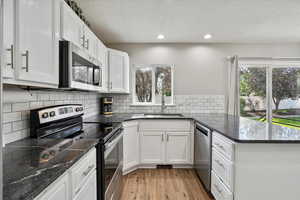 Kitchen featuring stainless steel appliances, a peninsula, and plenty of natural light