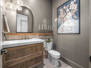 Bathroom with vanity, toilet, and tile patterned flooring