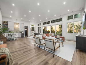 Living area featuring beverage cooler, light wood-style flooring, recessed lighting, and baseboards
