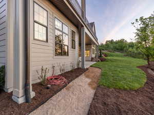View of side of property with a lawn