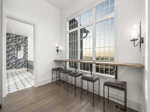 Dining area with baseboards, plenty of natural light, and wood finished floors