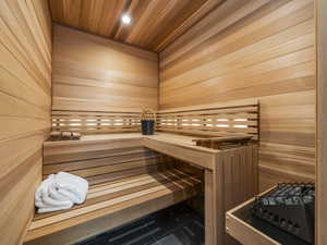 Relaxing sauna / steam room with wood ceiling, wood walls, tile patterned flooring, and recessed lighting