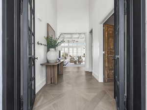 Foyer entrance featuring baseboards and a high ceiling