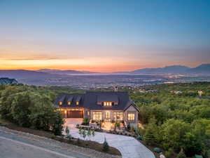View of front of house with a mountain view, driveway, and a garage