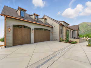 View of front of property featuring an attached garage, driveway, and a mountain view
