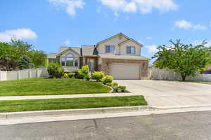View of front facade featuring concrete driveway, an attached garage, stucco siding, and brick siding