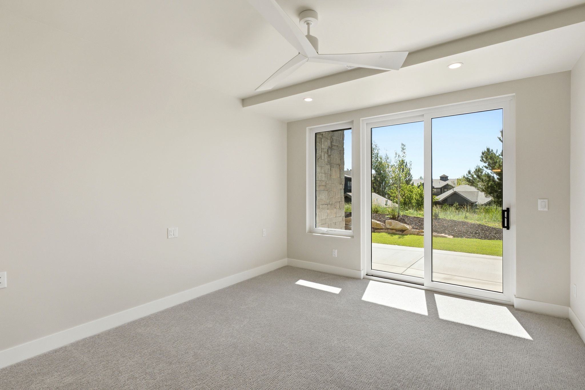 Room featuring light-colored carpeting, a contemporary ceiling fan, recessed lighting, and a sliding glass door providing exterior access