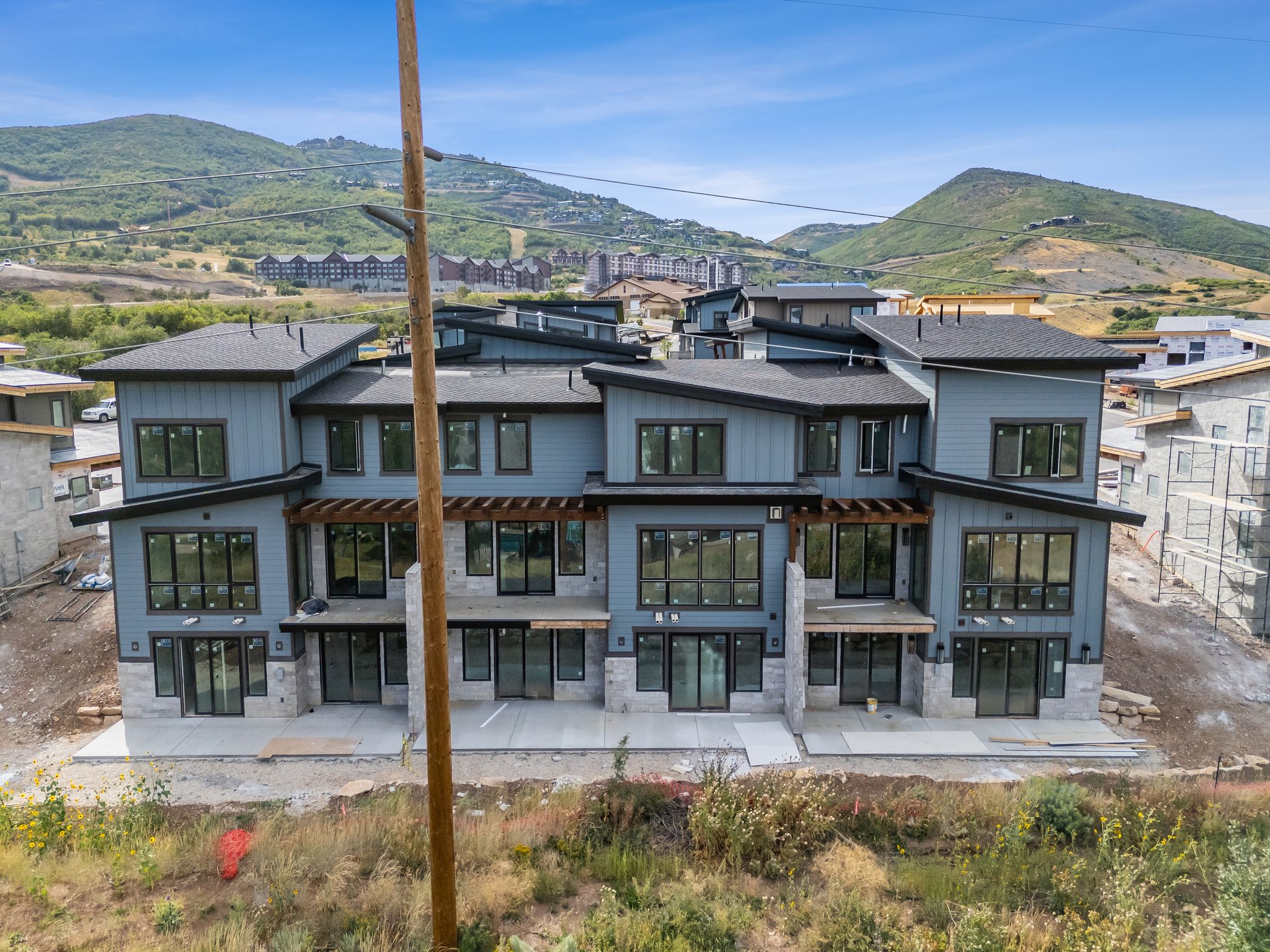 Rear view of house with stone siding, a mountain view, and a patio area