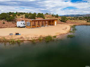 Back of property with a water and mountain view