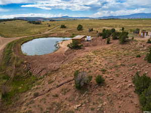 Overview of rural landscape featuring a water and mountain view