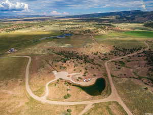Aerial overview of property's location featuring a mountainous background and rural landscape