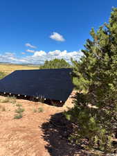 View of property exterior featuring solar panels