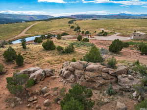 Aerial overview of property's location with a mountain backdrop and rural landscape