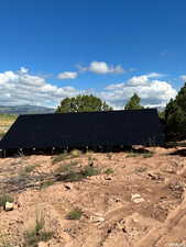 View of home's exterior featuring ground mounted solar panels