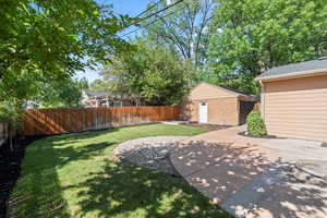 View of yard with a patio and detached garage