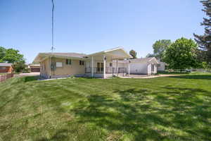 Back of property featuring brick siding and a patio