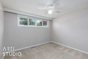 Unfurnished room with carpet flooring, ceiling fan, and baseboards