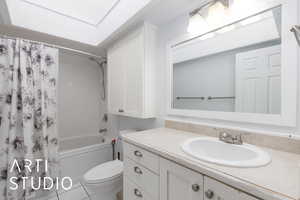 Full bath with vanity, shower / bathtub combination with curtain, and toilet