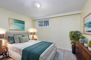 Bedroom featuring carpet flooring and baseboards