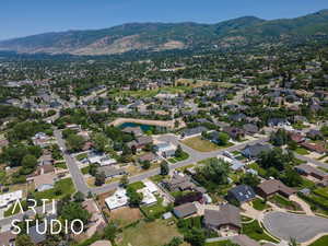 Aerial overview of property's location featuring a mountainous background and nearby suburban area