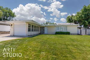 Mid-century modern home with concrete driveway and a garage