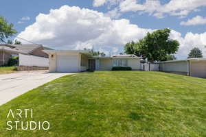 Ranch-style home featuring a garage and concrete driveway