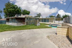 Back of house with a patio area and a playground