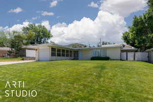View of front facade featuring a garage and driveway