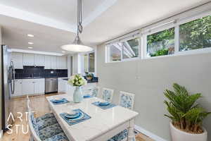 Dining area with light wood-style floors, recessed lighting, and baseboards