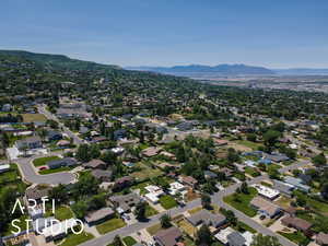 Aerial view of property's location with a mountain backdrop and nearby suburban area