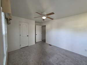 Unfurnished bedroom with carpet floors and a ceiling fan