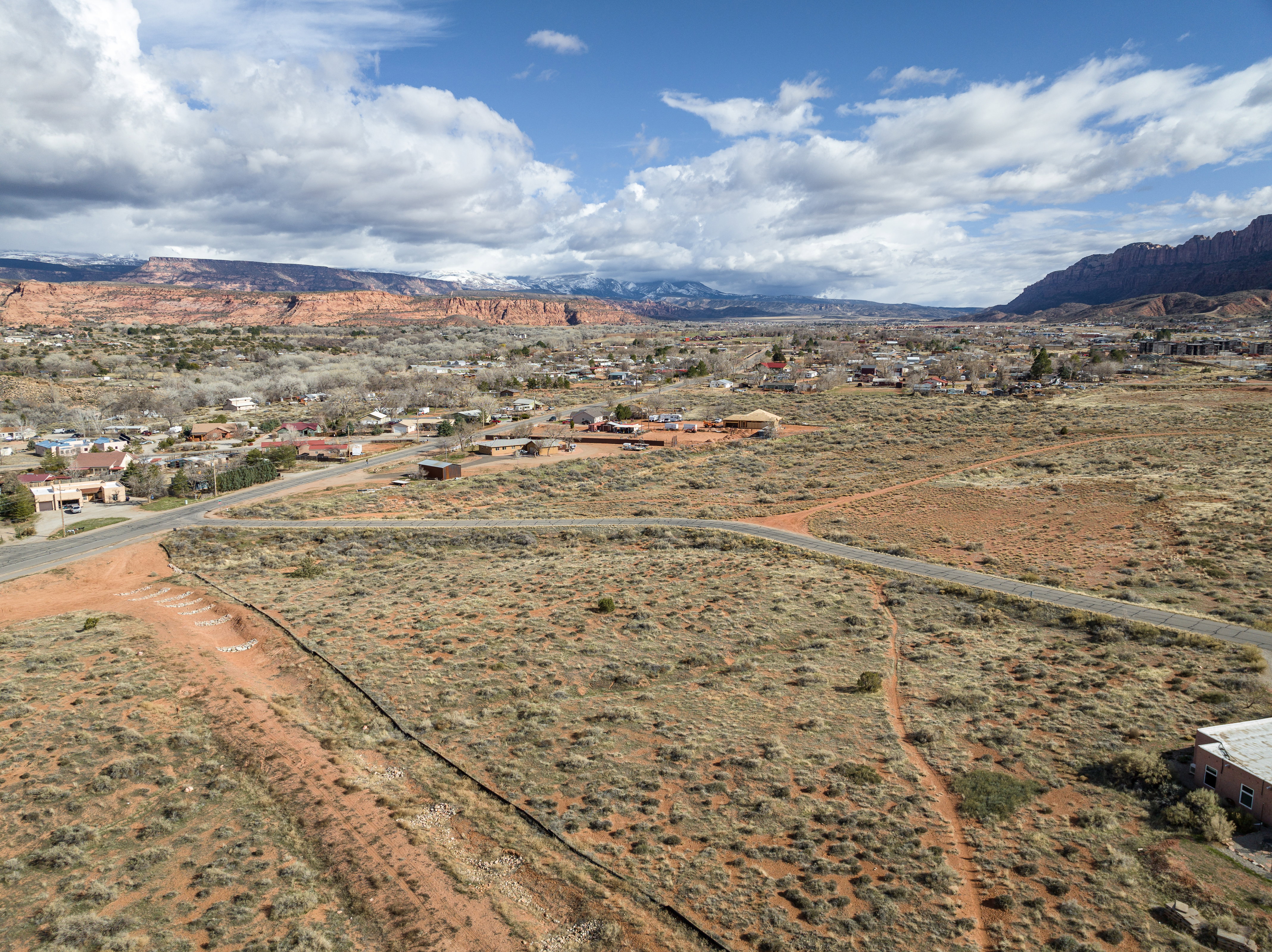 Aerial view of sparsely populated area with a mountain backdrop and a desert landscape