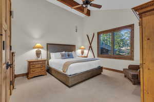 Carpeted bedroom featuring baseboards and a ceiling fan